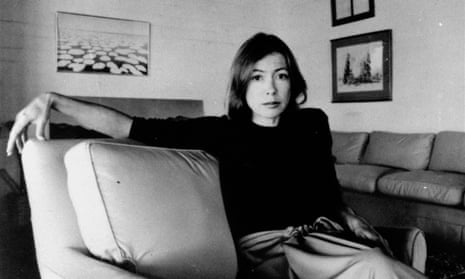 Joan Didion sitting on a sofa