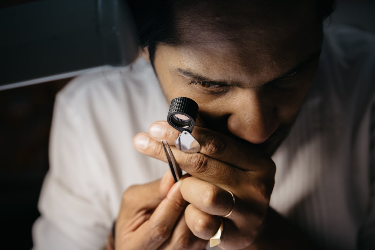 Akshat Ghiya checking the clarity of a batch of diamonds at his workshop-store Tallin, in Jaipur.
