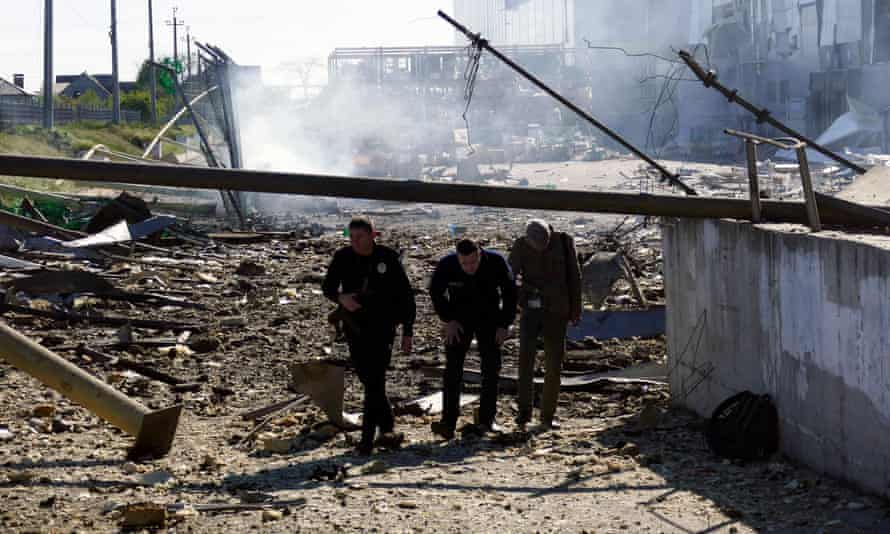 People walk at a site of a shopping centre destroyed by shelling amid Russia’s invasion of Ukraine, in Odesa, Tuesday May 10.