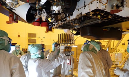 Engineers and technicians insert 39 sample tubes into the belly of the Mars rover Kennedy Space Center, Florida, May 2020.