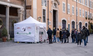 People queue outside a rapid Covid-19 testing site for antigenic swabs amid a rise in Covid-19 infections driven by the Omicron variant.