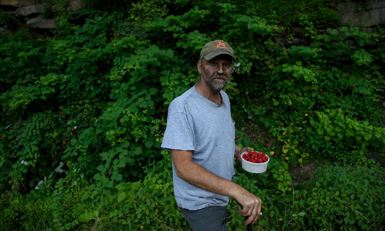 Chuck Denton, 52, picks raspberries after a shift at the coalmine.
