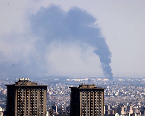 Smoke billows in the distance from an oil refinery following an Israeli strike on the Iranian capital Tehran on Tuesday.