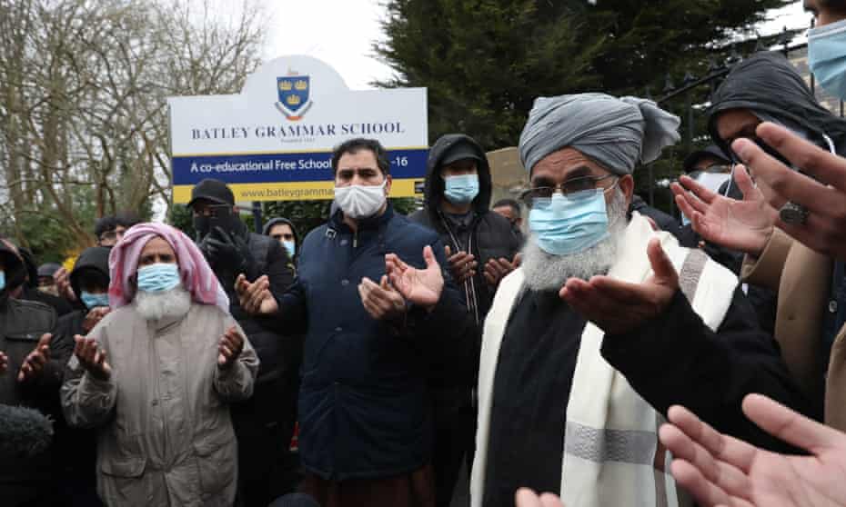 Protesters take part in a prayer outside Batley grammar school