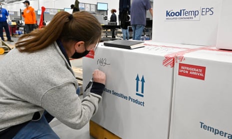 Melissa Owens, operations plant manager for the McKesson Corporation, signs the first shipping box of the Johnson and Johnson Covid-19 vaccine in Shepherdsville, Kentucky, on Monday.