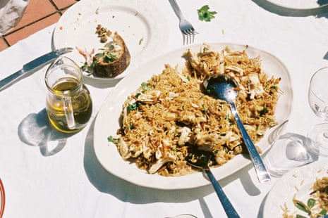 Chicken pilaf on a white plate on a table with a white tablecloth outdoors