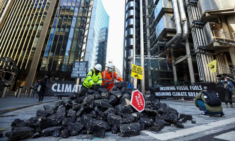 Environmental activists protest outside the Lloyd’s building in London.