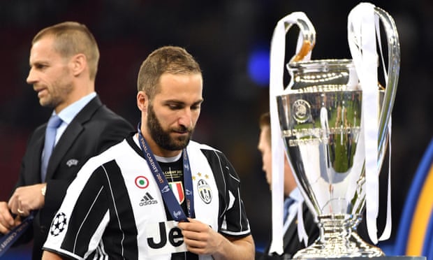 Higuaín has to walk past the Champions League trophy after his Juventus side were beaten 4-1 in the final by Real Madrid in June.