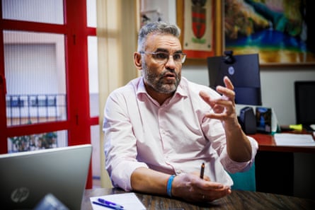 Nuñez Perez, seated, gesticulates while making a point