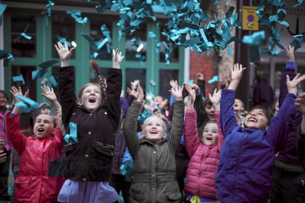 Children catch paper helicopters falling from the sky during Hull’s tenure as UK City of Culture, 29 June 2017.