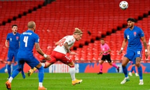 Denmark’s Daniel Wass heads over the bar.