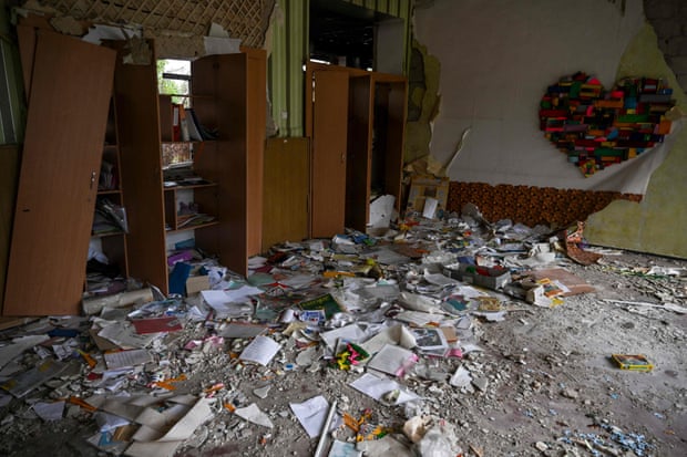यूक्रेन के इज़ुइम में एक कक्षा में किताबें और अन्य मलबा बिखरा पड़ा है