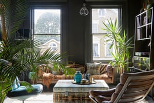 ‘Vintage things have more soul’: a mix of styles and colours in the living room is achieved with a vibrant yucca plant and areca palm against grey walls and reupholstered furniture.