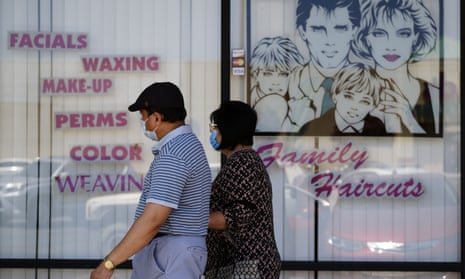 A couple walk by a closed hair salon in Los Angeles on Tuesday. Unless lawmakers step in, the $600 weekly payment will expire on 31 July.