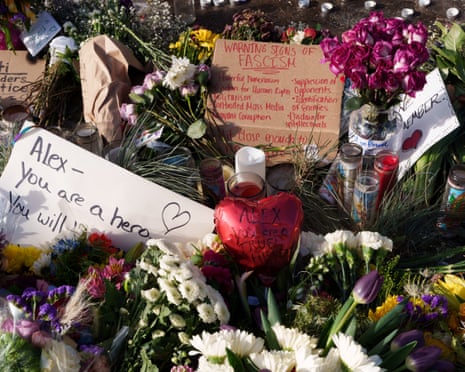 Flowers, candles, and signs laid at a makeshift memorial located where Alex Pretti was fatally shot by federal agents in Minneapolis.