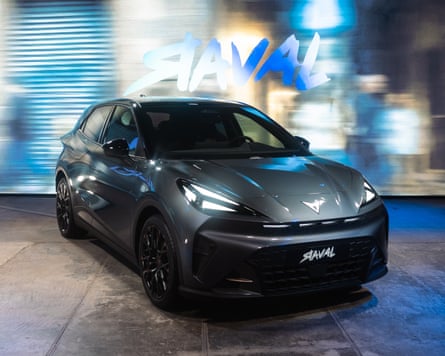 A grey Cupra Raval electric car at an indoor promotional event