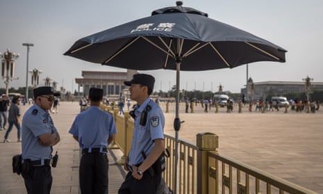 Chinese policemen stand guard on the Tiananmen Square in Beijing, China