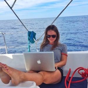 girl with laptop on a boat against sea backdrop