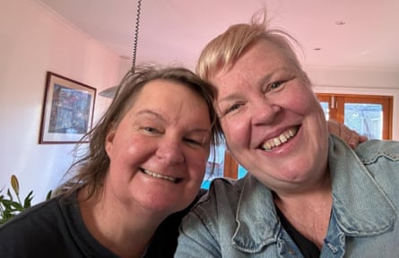 Headshot of two women close together, grinning at the camera