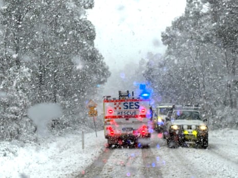 An SES truck and other vehicles on a snow-covered road