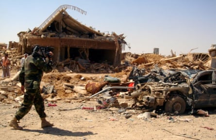 An Iraqi soldier videotapes the ruins of a coordinated suicide attack in the town of Qahataniya, 75 miles west of Mosul, Iraq, 15 August 2007