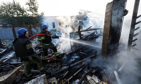 Firefighters work at a site in a residential area, damaged during a Russian missile strike in Kyiv