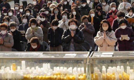 Parents pray to wish for their children’s success in a college exam, at the Jogyesa temple in Seoul.