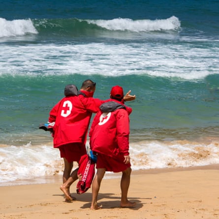 Rescue teams walk on the beach in San Sebastián