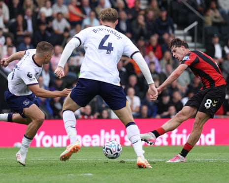 Bournemouth's Alex Scott strikes the ball to score, as two Everton players close in