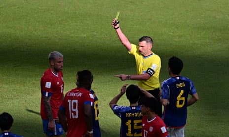 The referee shows a yellow card to Francisco Calvo.