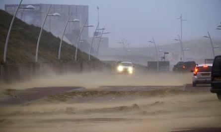 Sand is blown on to the road by gales in The Hague.