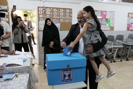 Mansour Abbas, leader of the Ra’am party, casts his ballot alongside his family on Tuesday.
