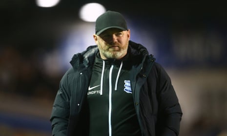 Wayne rooney in a black cap standing on the sideline.