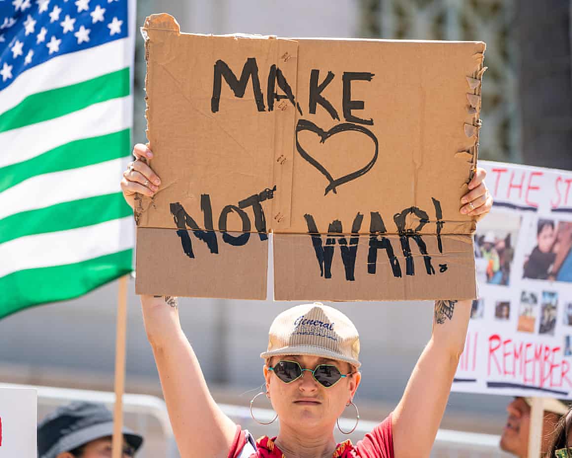 a woman holding an anti-war sign