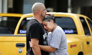 Ray Rivera, left, a DJ at the Pulse Orlando nightclub, is consoled by a friend, outside of the Orlando police department.