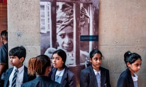 Schoolchildren under a portrait of Winnie Madikizela-Mandela