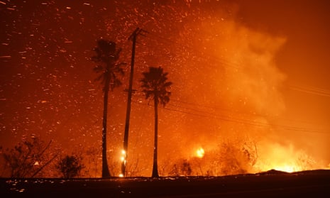 A power line catches fire as the Woolsey fire burns on both sides of Pacific Coast Highway in Malibu, California, on 9 November. 