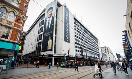 A large white modernist building draped with large House of Fraser banners