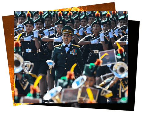 A soldier in ceremonial uniform and holding up a sword shouts orders to her colleagues marching in formation behind her. In the foreground a marching band precedes her.