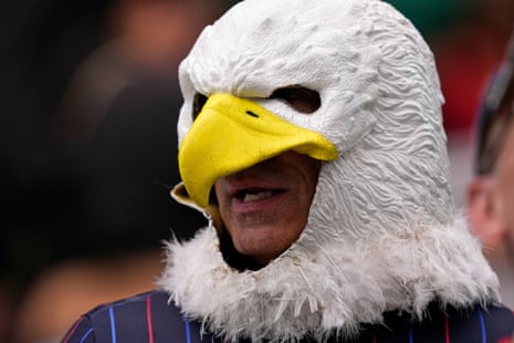 A US fan wears a bald eagle head before the game in Houston