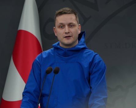 Greenland’s prime minister, Jens-Frederik Nielsen, speaks into microphone while wearing his signature blue anorak