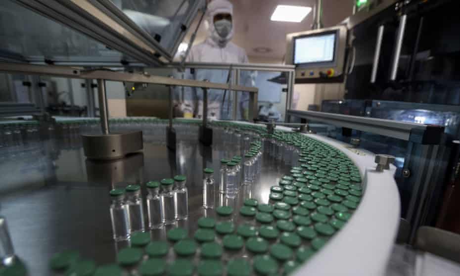 A worker fills Covid-19 vaccine phials at the Serum Institute of India factory in Pune