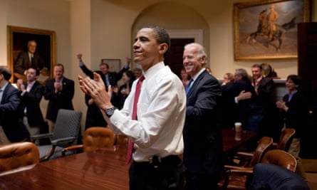 President Barack Obama, Vice President Joe Biden, and senior staff applaud in the Roosevelt Room of the White House, as the House passes the health care reform bill