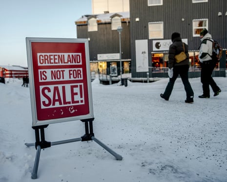 People walk along an icy street in Nuuk, Greenland.