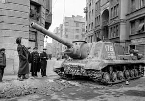 Los transeúntes se mira un tanque soviético desactivada después de la primera salida Soviética. Las personas vagaban por las calles, resulta difícil de creer que habían conducido al enemigo