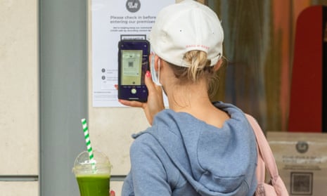 A woman checks in to a shop using a QR code