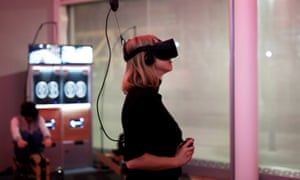 A woman playing a video game using the Oculus Rift VR headset.