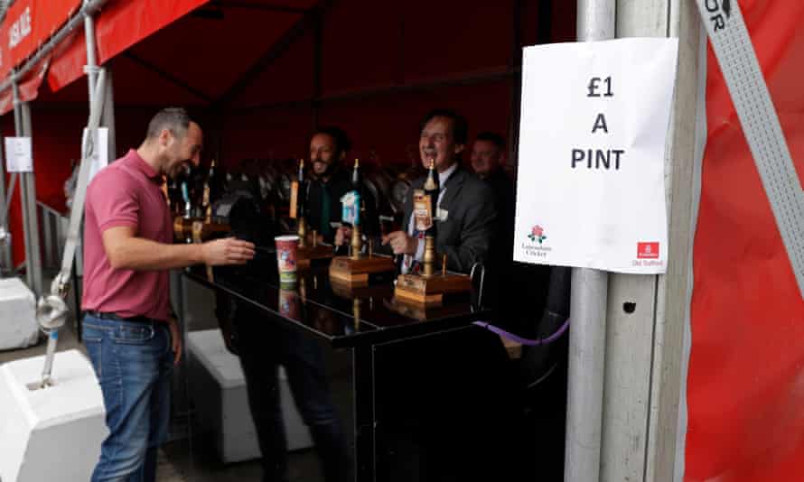 Every cloud … a spectator buys a reduced pint at Old Trafford after the fifth Test was cancelled on Friday morning.