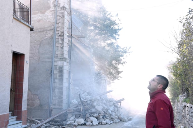 A man inspects a collapsed building in Borgo Sant’Antonio.