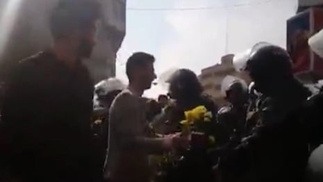 Protesters filmed handing flowers to Iranian police in video posted to Telegram Messenger